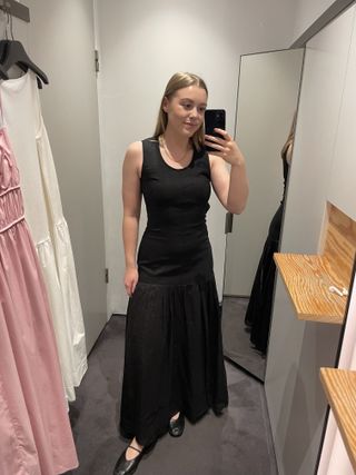 Woman in black dress and ballet flats