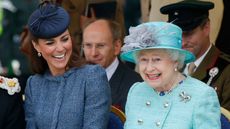 Catherine, Duchess of Cambridge and Queen Elizabeth II watch part of a children's sports event while visiting Vernon Park during a Diamond Jubilee visit to Nottingham on June 13, 2012