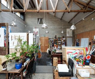 An art studio with numerous paintings and sculptures