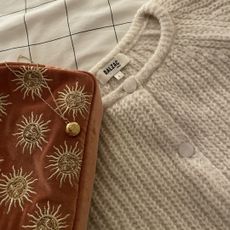 tried and tested gifts: gold necklace, makeup bag, and knitted jumper from the gift guide