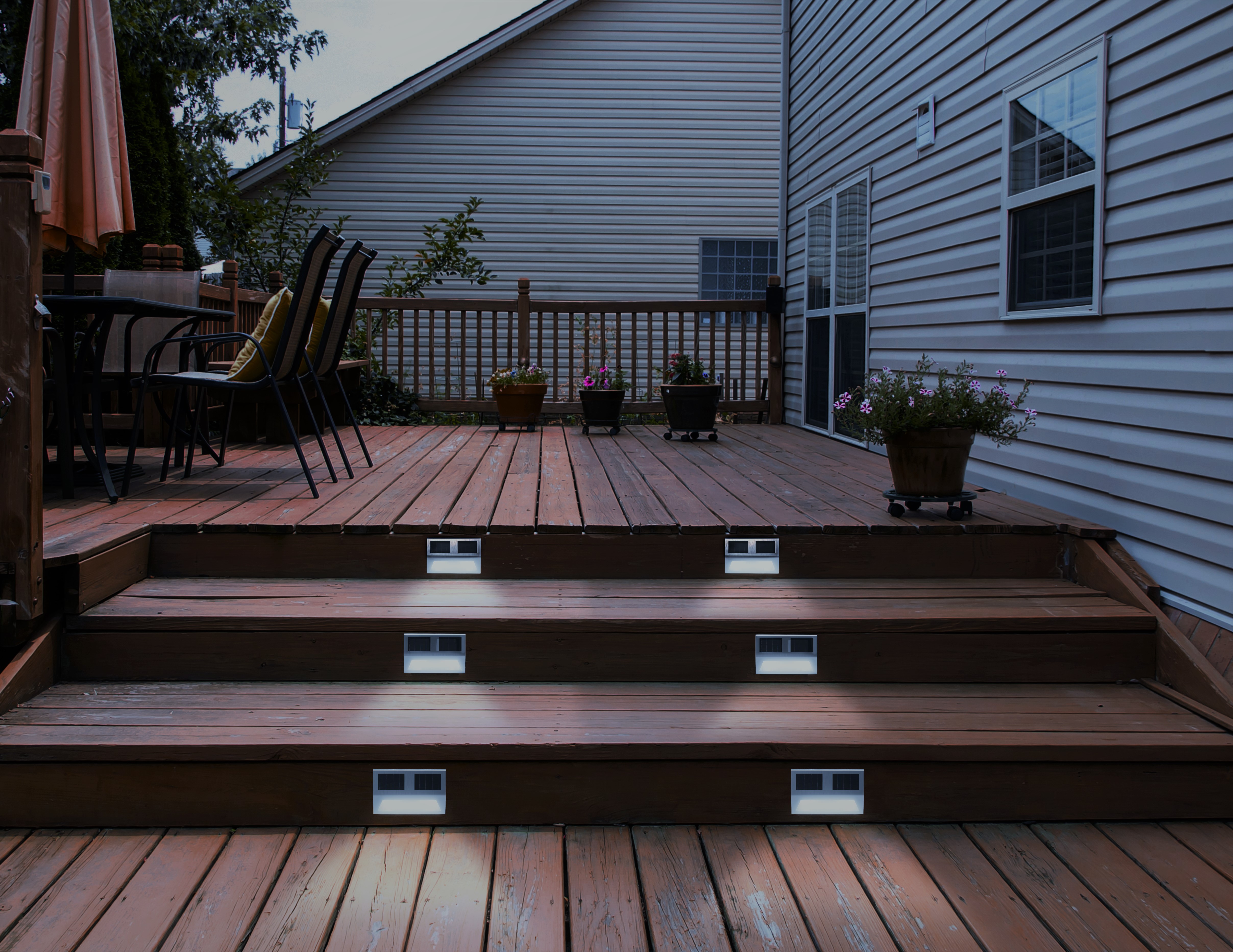 Deck lights on steps in backyard