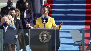 Amanda Gormon stands at podium while reciting her speech during the presidential inauguration.