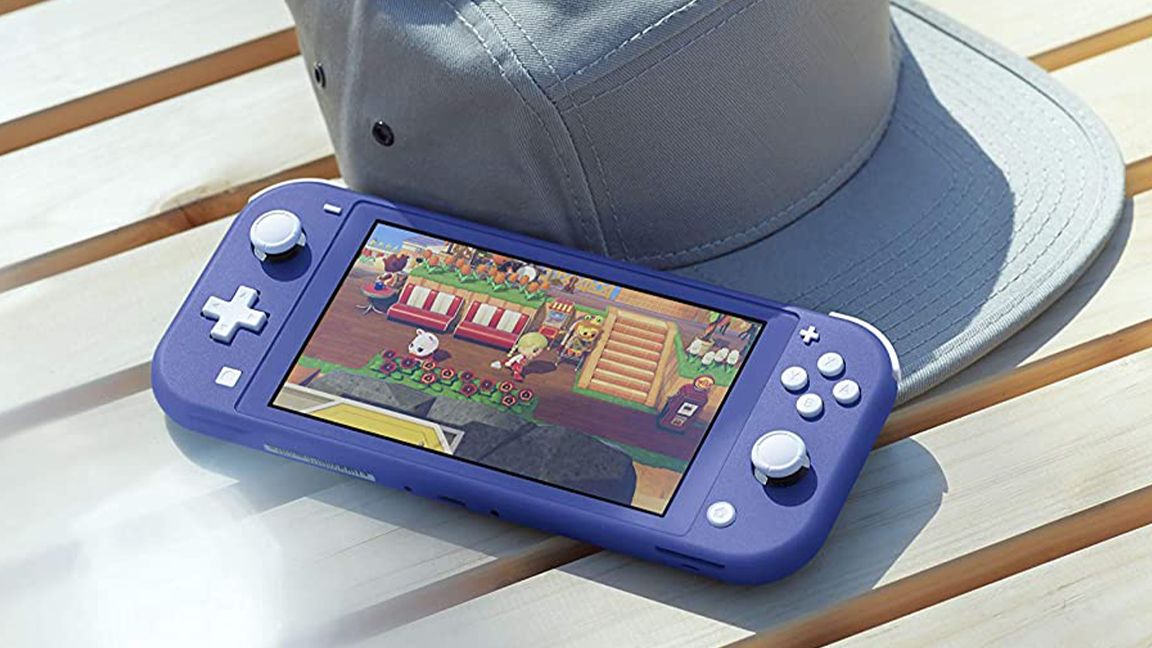 A photo of a Nintendo Switch Lite on a bench next to canvas cap
