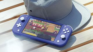 The best Nintendo Switch Lite games, photo of a Nintendo Switch Lite on a bench next to canvas cap