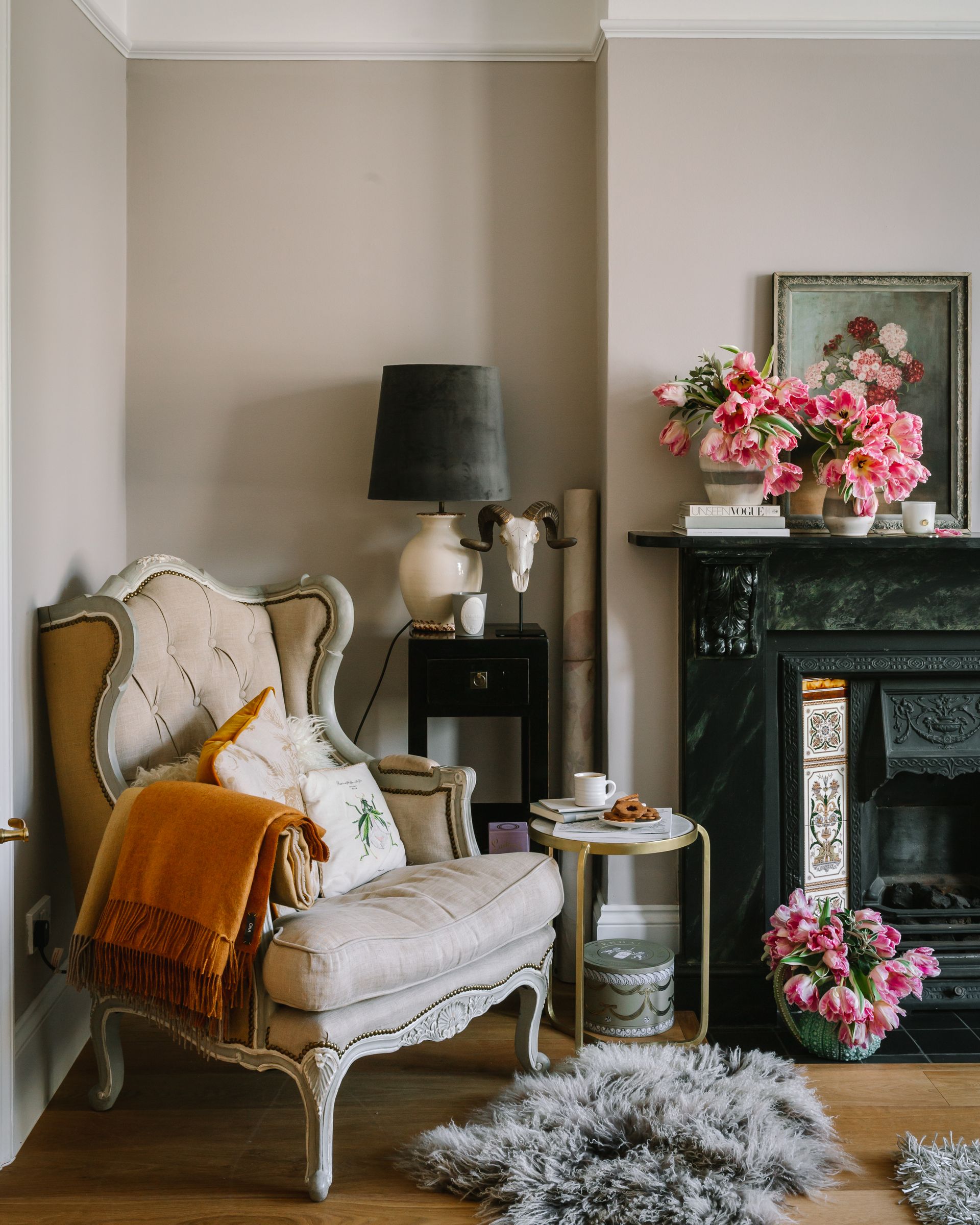 grey living room wit cozy rugs, blanket and flowers by Mylands