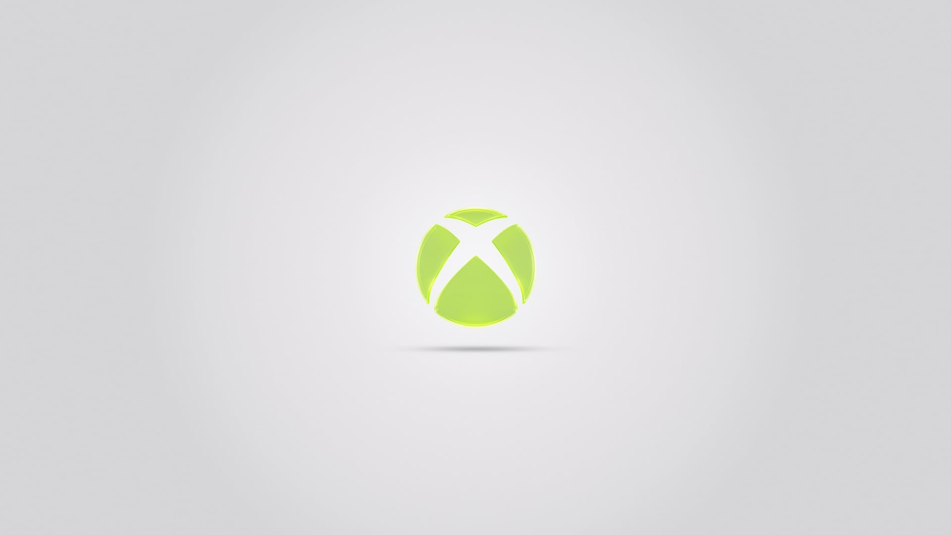 Xbox logo in bright green on a clean light grey background, centered with a subtle shadow beneath, giving a minimal and modern look.