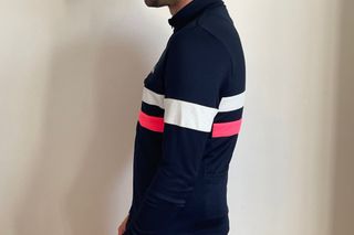Image shows the reflective white armband of the Rapha Brevet long sleeve jersey.