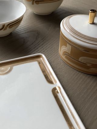 White porcelain tableware by Andre Fu with brown and gold gilded motifs