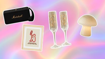 Graduation gifts on hollographic pink background with Marshall speaker, wall art, gold glasses and a mushroom lamp