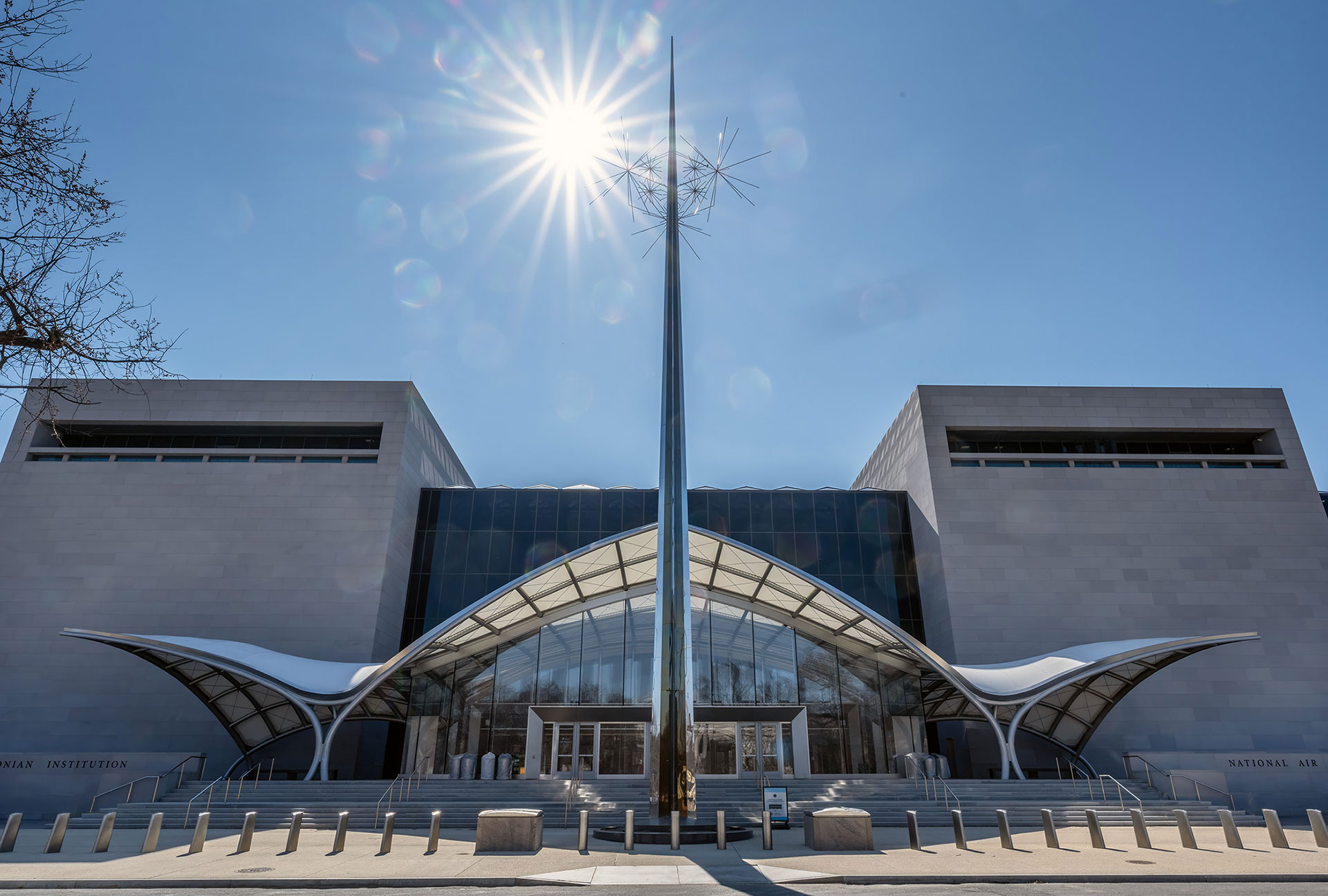 a wing-shaped covering forms the entranceway into a building.
