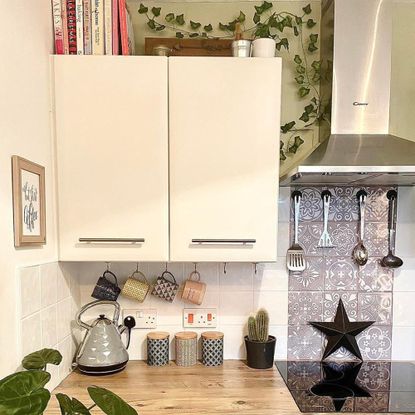 White kitchen with cabinets and black and white splashback