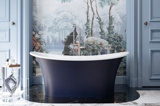 Interior room, marble floor, blue and white free standing bathtub, pale blue doors, landscape painted landscape wall art behind the bathtub, glass feature side table