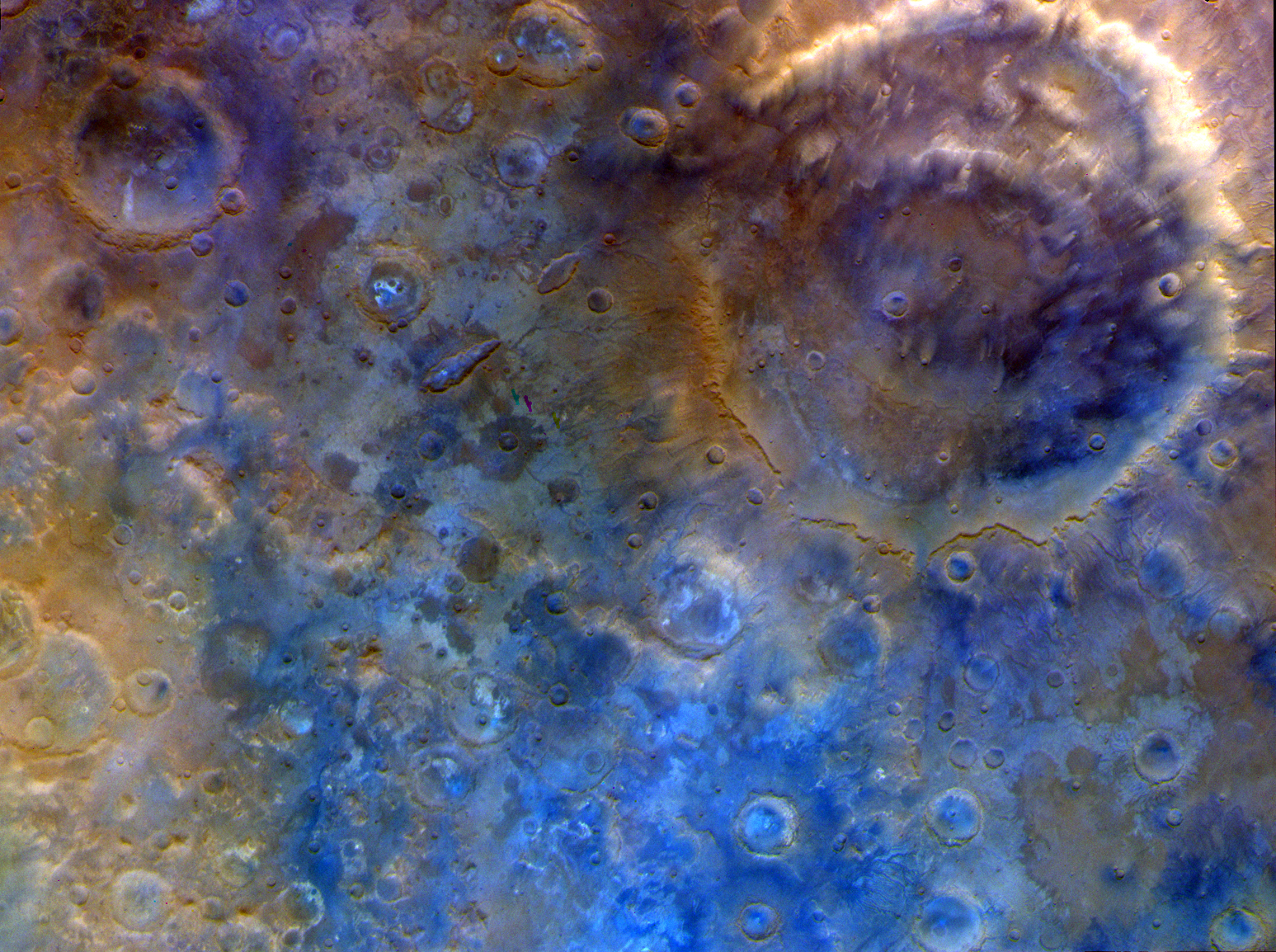 An image of Mars captured by NASA's Psyche spacecraft shows dramatic colors across a cratered surface