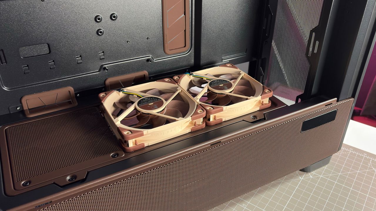 The Antec Flux Pro Noctua Edition on a desk with various parts disassembled.