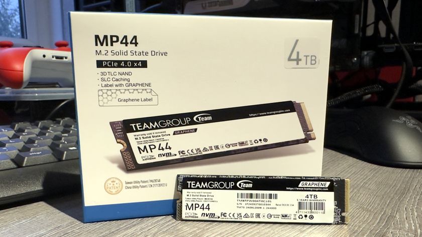 A photo of a Team Group MP44 SSD next to its retail packaging