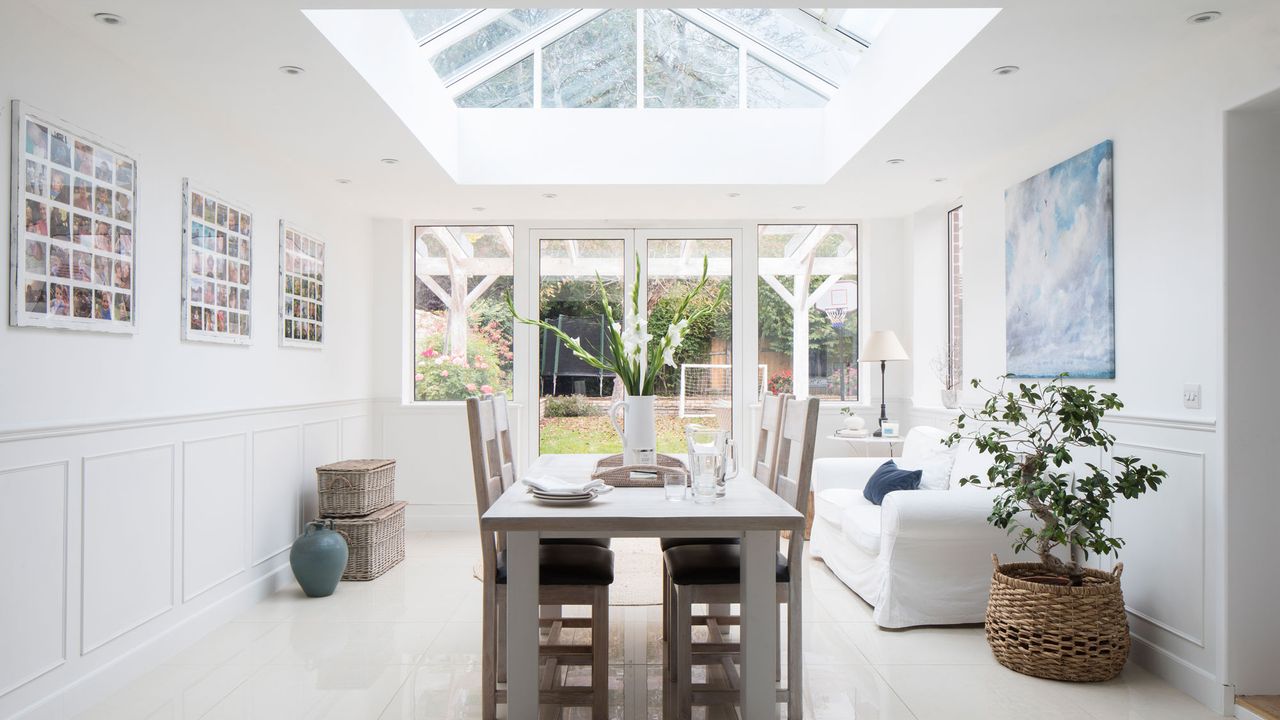 White kitchen family room with table and chairs and white sofa