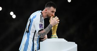 Inter Miami target Lionel Messi of Argentina kisses The FIFA World Cup Qatar 2022 Winner's Trophy after the team's victory during the FIFA World Cup Qatar 2022 Final match between Argentina and France at Lusail Stadium on December 18, 2022 in Lusail City, Qatar.