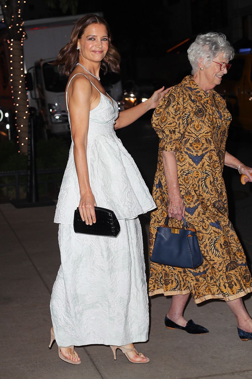 Katie Holmes wearing a long white dress with tan suede high-heel thong sandals in NYC.