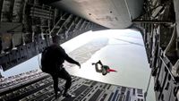 Maj. David Reifenberg, combat rescue officer drop zone controller, 308th Rescue Squadron, Patrick Space Force Base, Florida, free falls from a Joint Base Charleston C-17 Globemaster III, as Senior Master Sgt. George Reed, pararescueman, 308 RQS prepares to jump, during a Human Space Flight Support airdrop search and rescue exercise Jan 15, 2025, near Patrick SFB, Fla. 