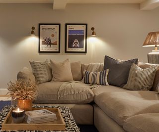 cosy living room with cream corner sofa and layered lighting