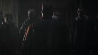 The Batman staring down the thugs