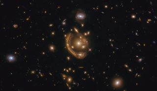 The narrow galaxy elegantly curving around its spherical companion in this image is a fantastic example of a truly strange and very rare phenomenon — gravitational lensing.