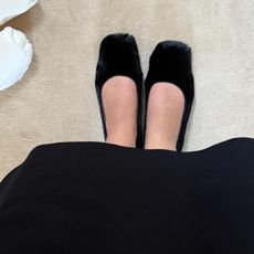 @christietyler wearing a black pair of The Row calf hair ballet flats.