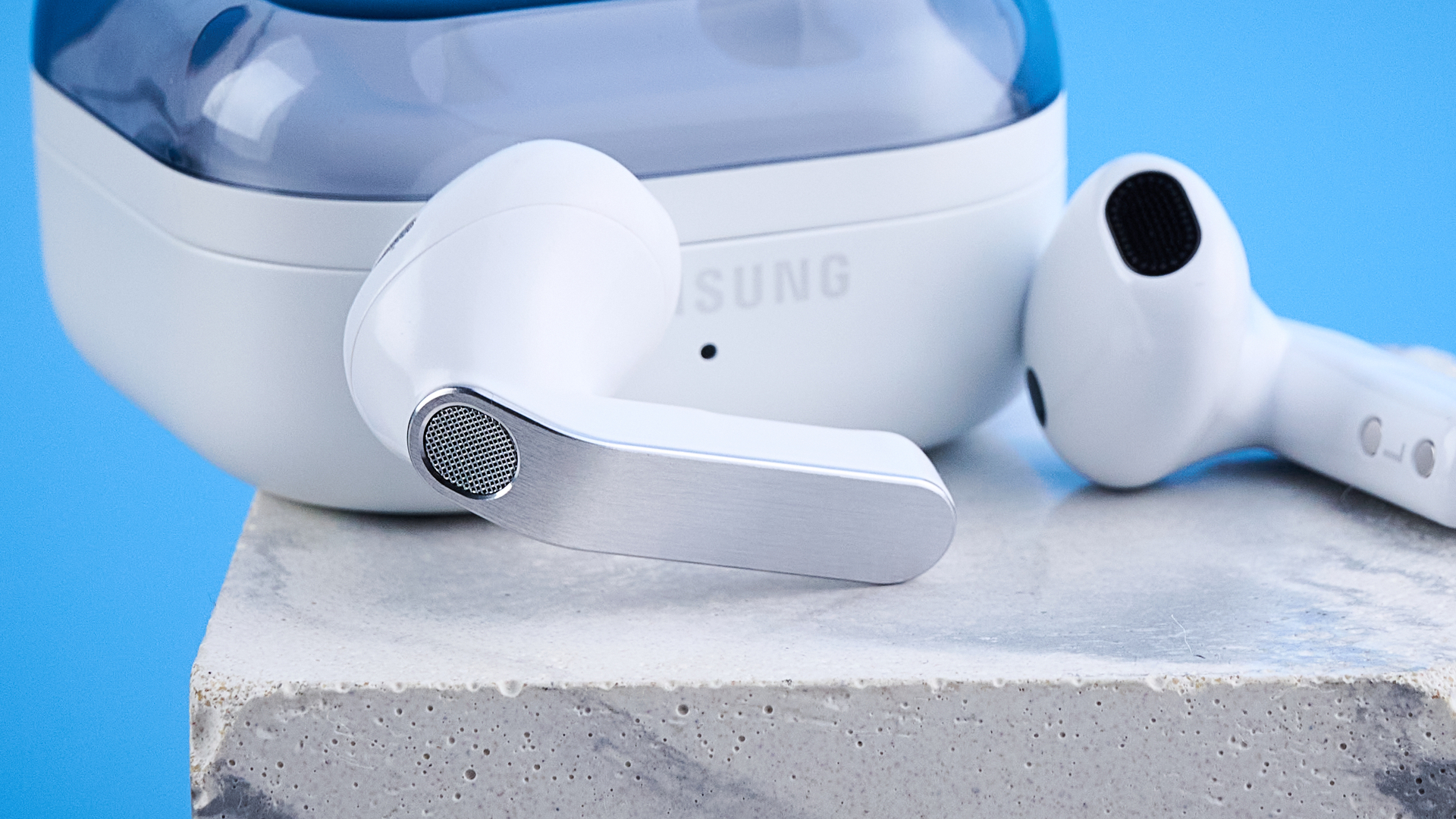the samsung galaxy buds 4 photographed against the blue tom's guide background showing charging case and buds