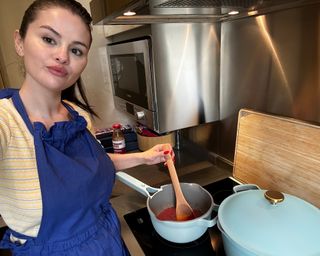Selena Gomez using the Our Place X Selena Gomez Mini Always Pot in Cielo blue in kitchen