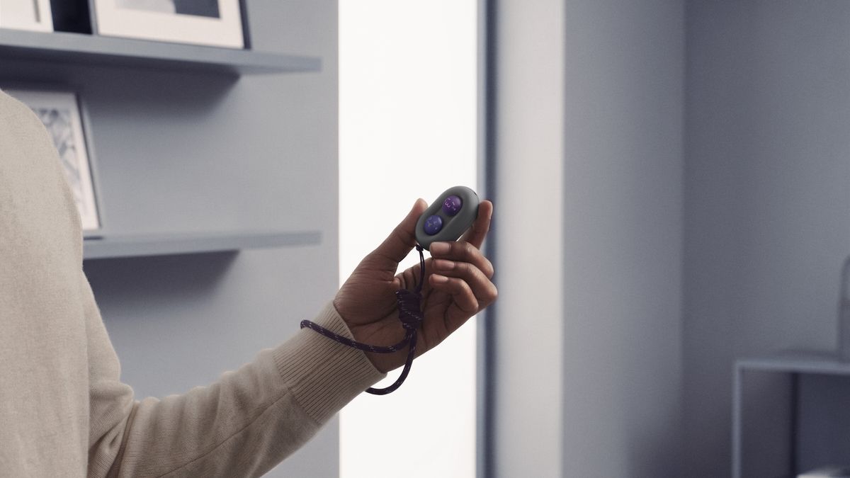 The DuRoBo Moodi in a model's hand, showing off its cute purple and pink emoji caps.