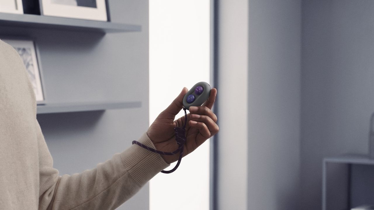 The DuRoBo Moodi in a model's hand, showing off its cute purple and pink emoji caps.
