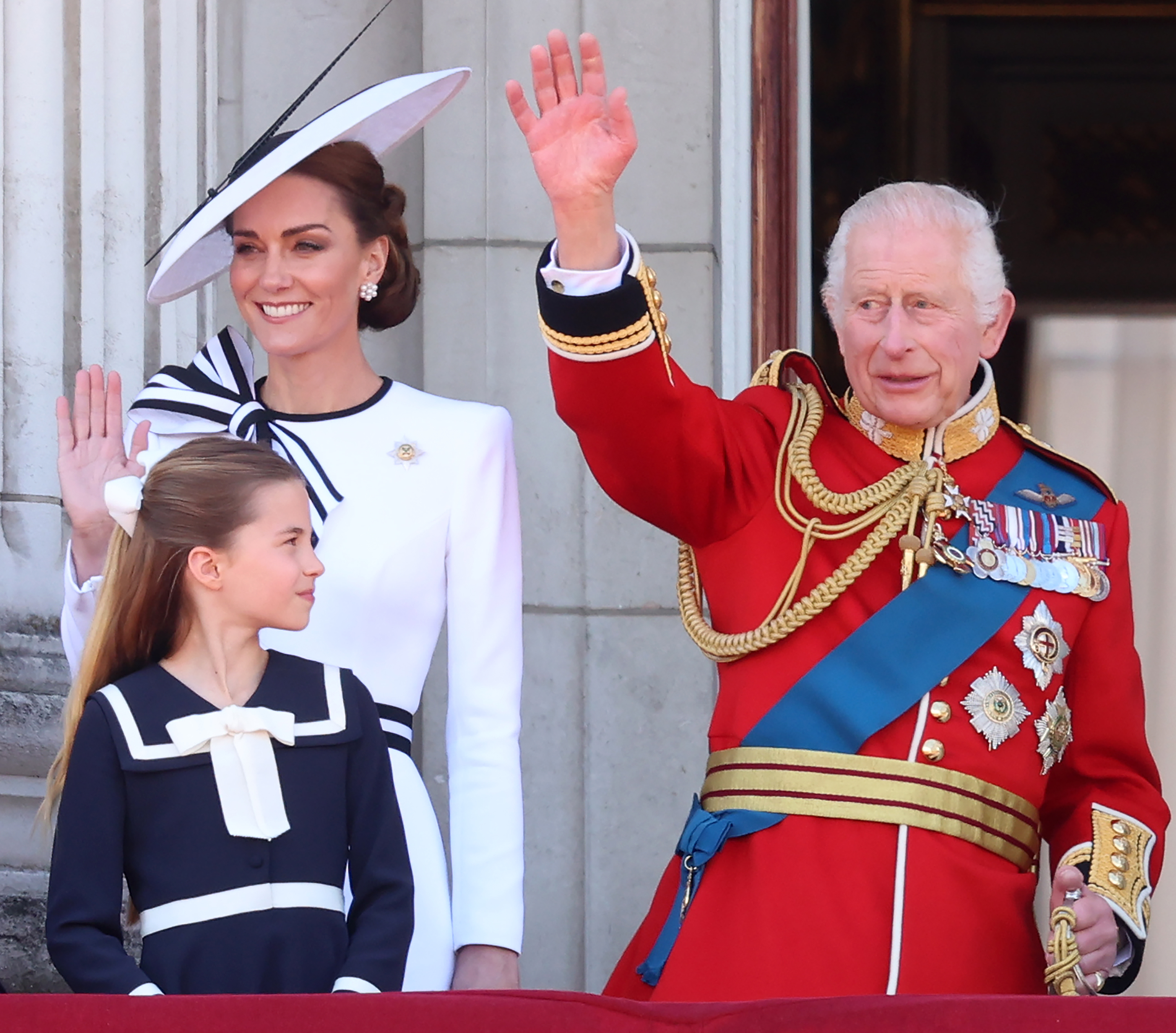 King Charles, Princess Charlotte and Princess Kate waving from the balcony at the palace