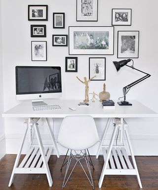 home office with white wall apple monitor and keyboard