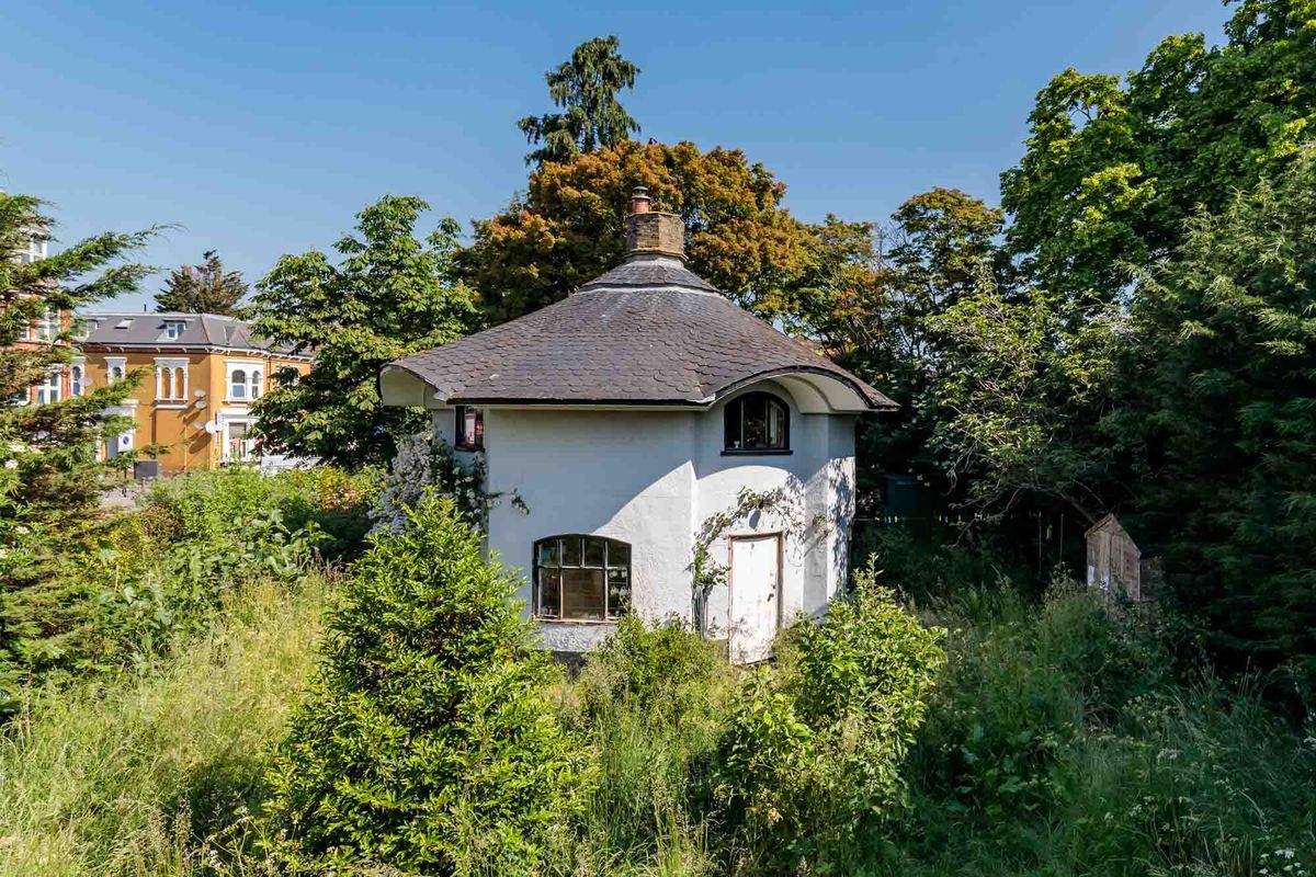 The house has an overgrown garden but is separated from all surrounding homes