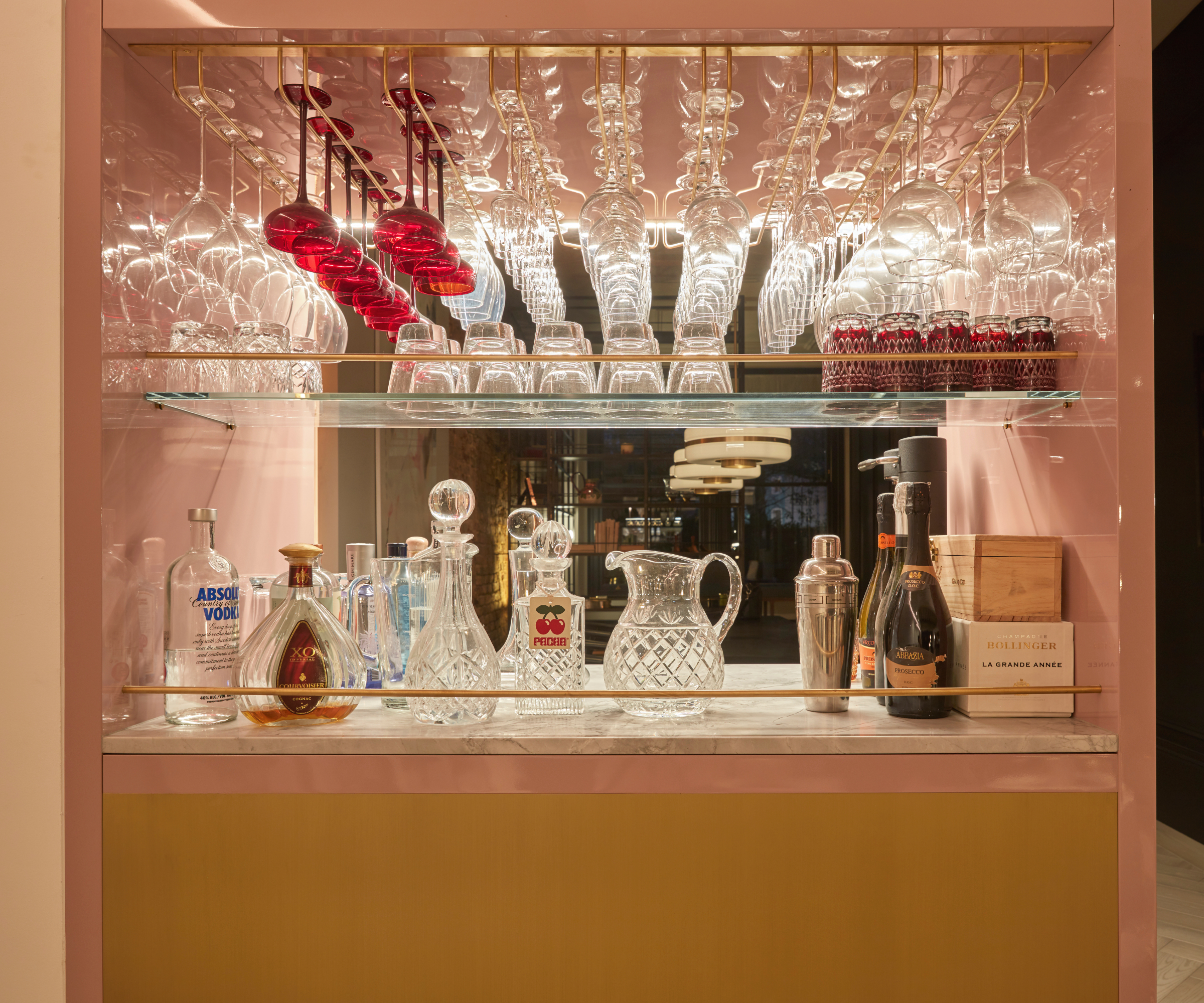 Glasses on display in home bar with mirrored splashback