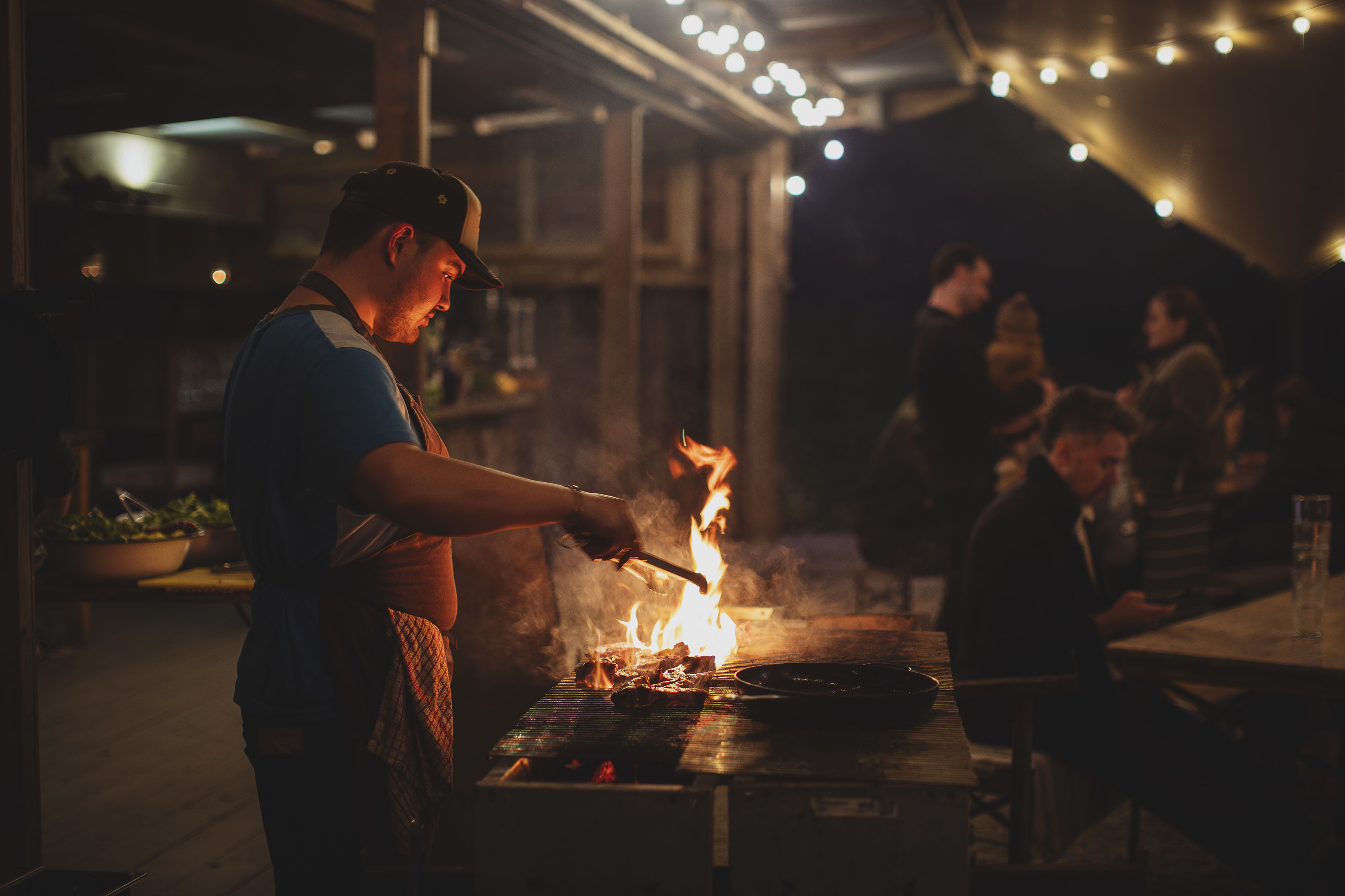 Man grilling over an open fire