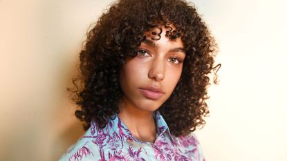 model with oily skin and curly hair