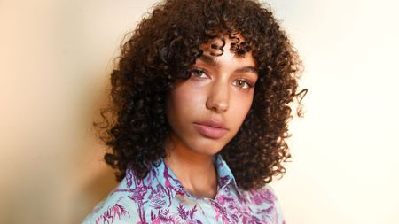 model with oily skin and curly hair