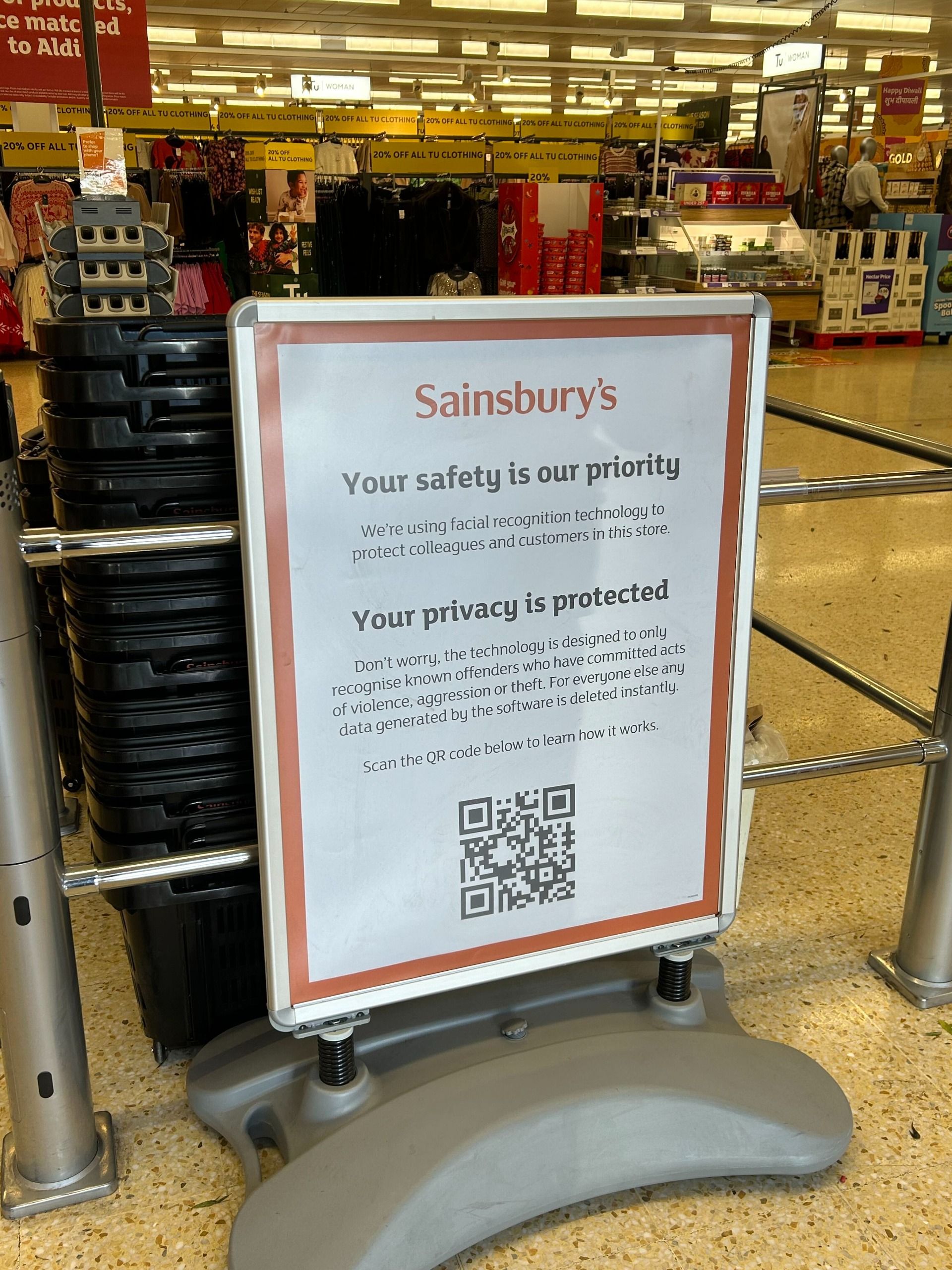 An in-store Sainsbury's sign explaining live facial recognition technology and privacy terms.