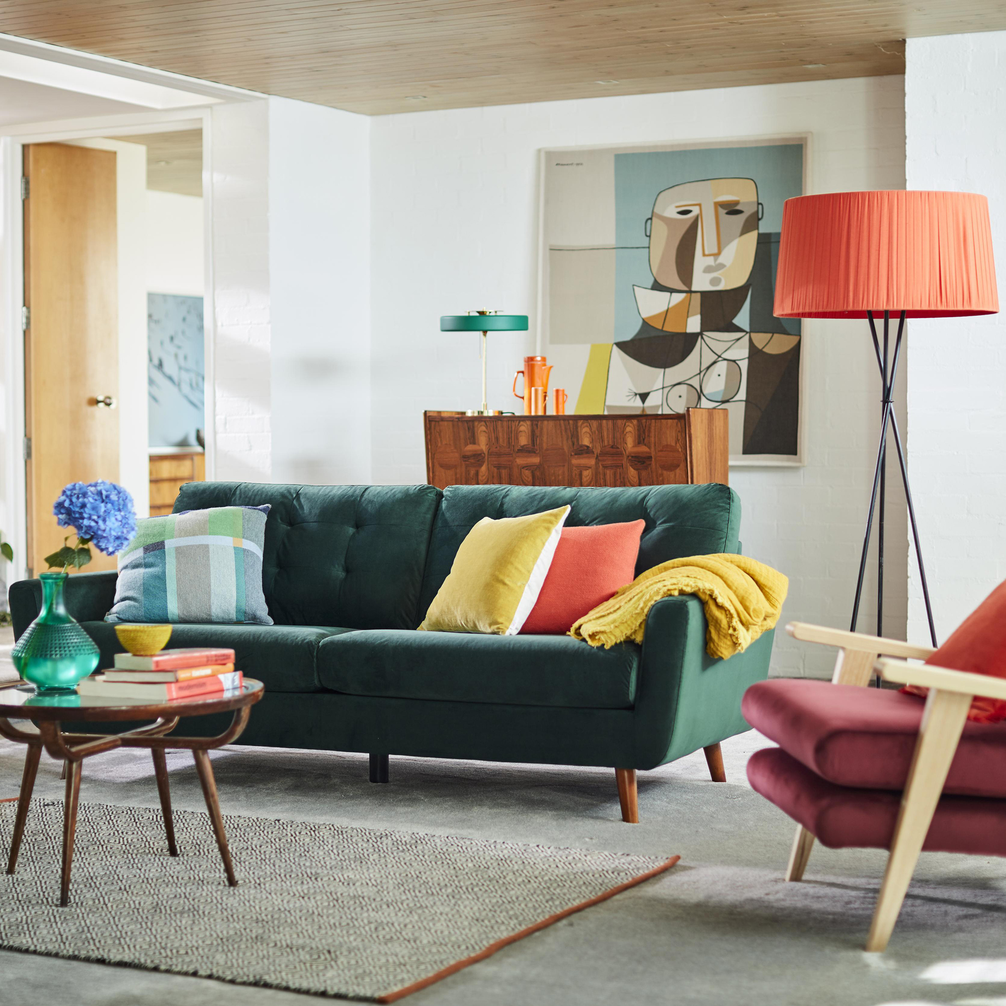 living room with white wall and green sofa