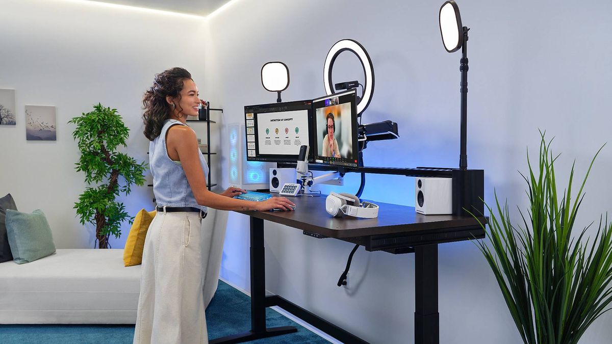 Corsair standing desk with femme presenting player standing on left