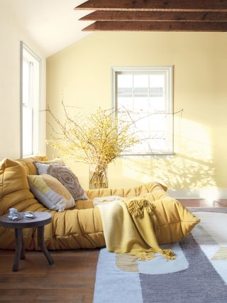 a yellow room with a togo sofa