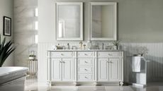 A white double bathroom vanity with multiple drawers in a galmorous white bathroom