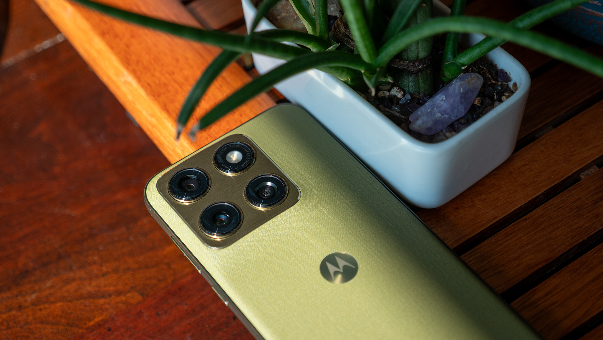 The back of the olive green Motorola Edge 2026 with its metal camera island