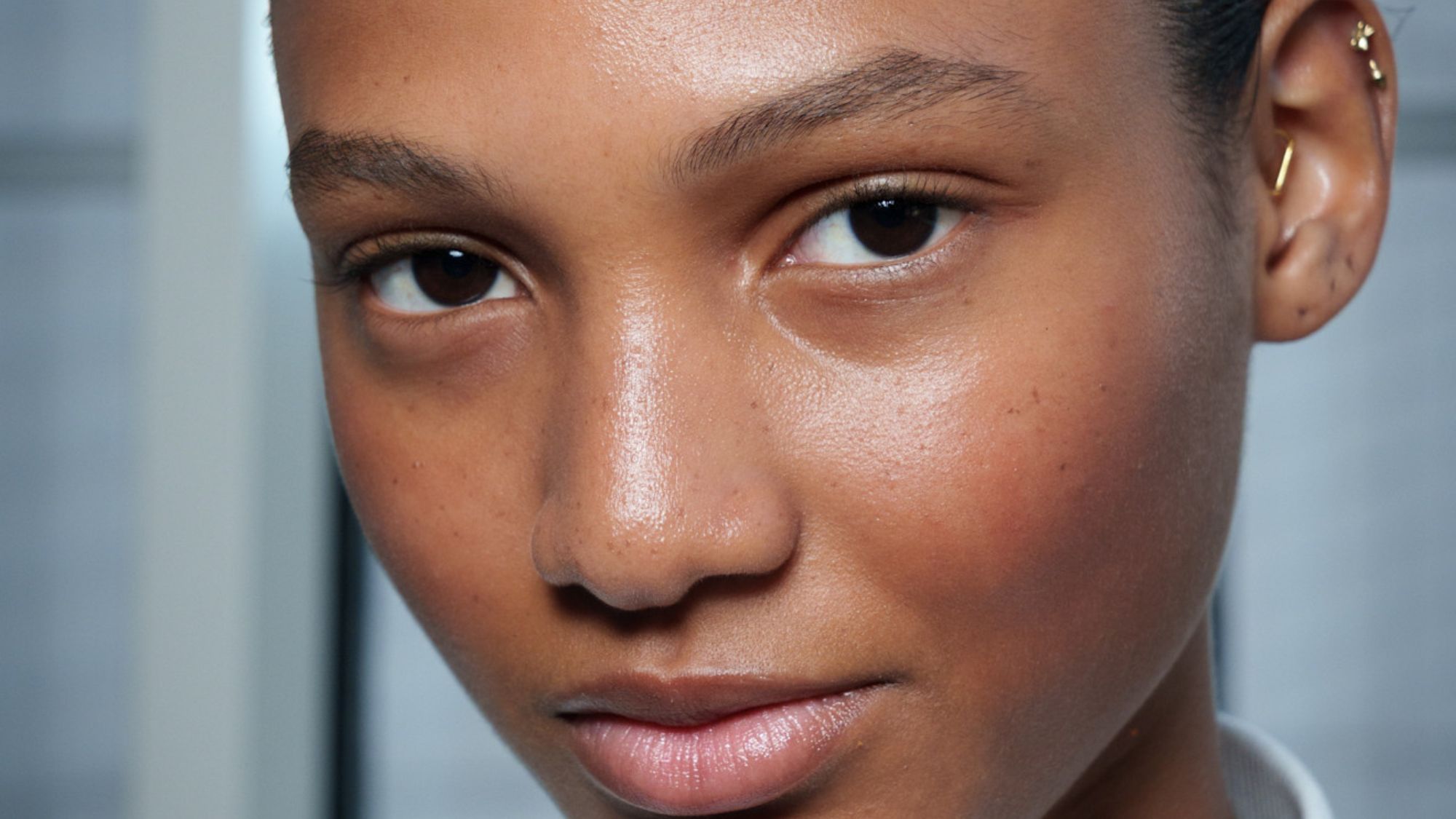 headshot of model backstage with glowy skin