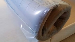 Simba Hybrid Essential Mattress rolled up in plastic