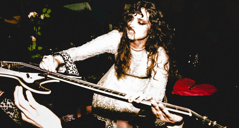 Demi Demitro of the Velveteers places her guitar in the hands of the crowd 