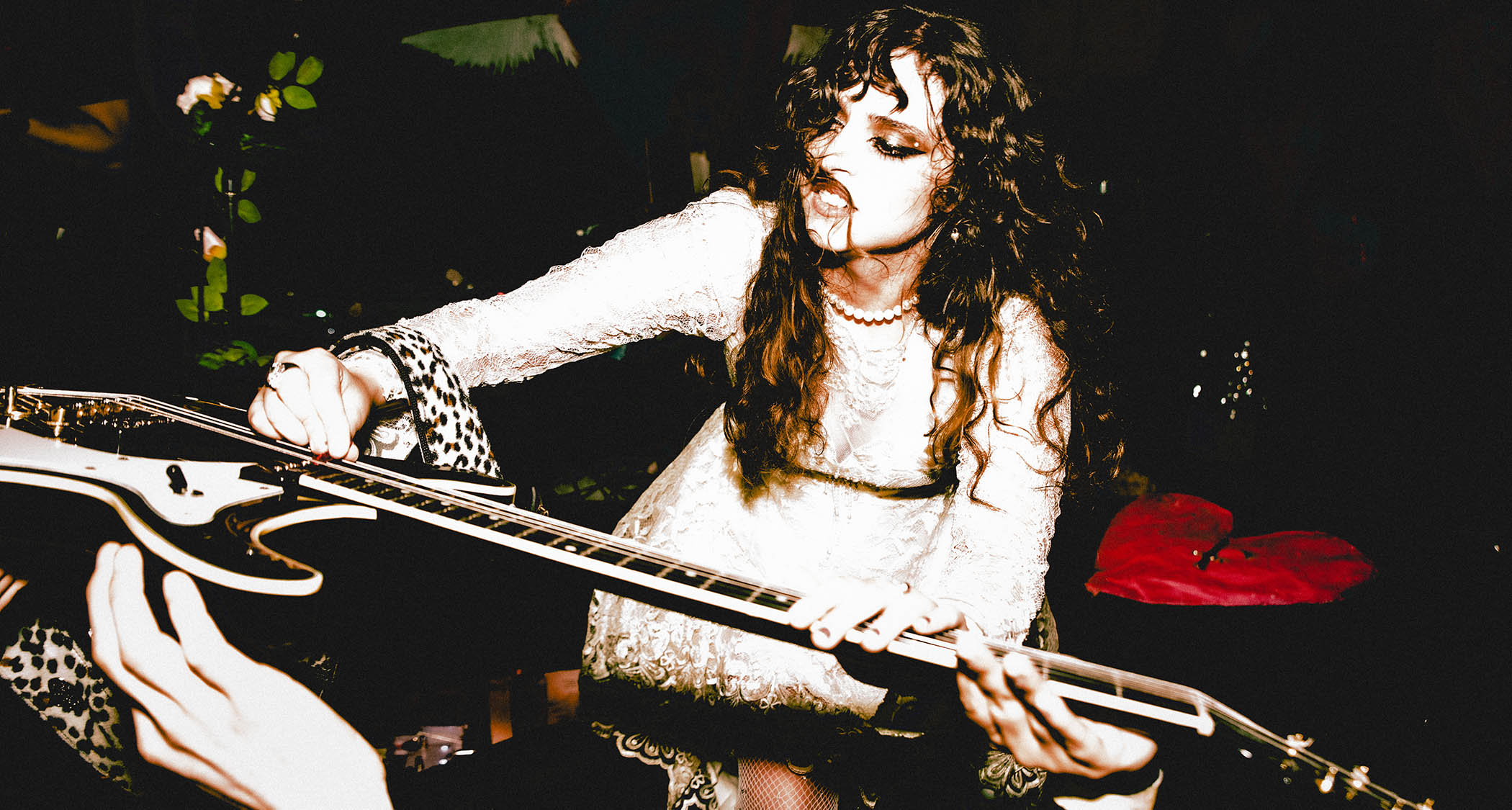 Demi Demitro of the Velveteers places her guitar in the hands of the crowd 