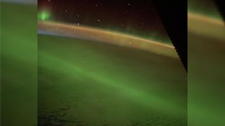 A photo of a large green aurora over the Indian Ocean