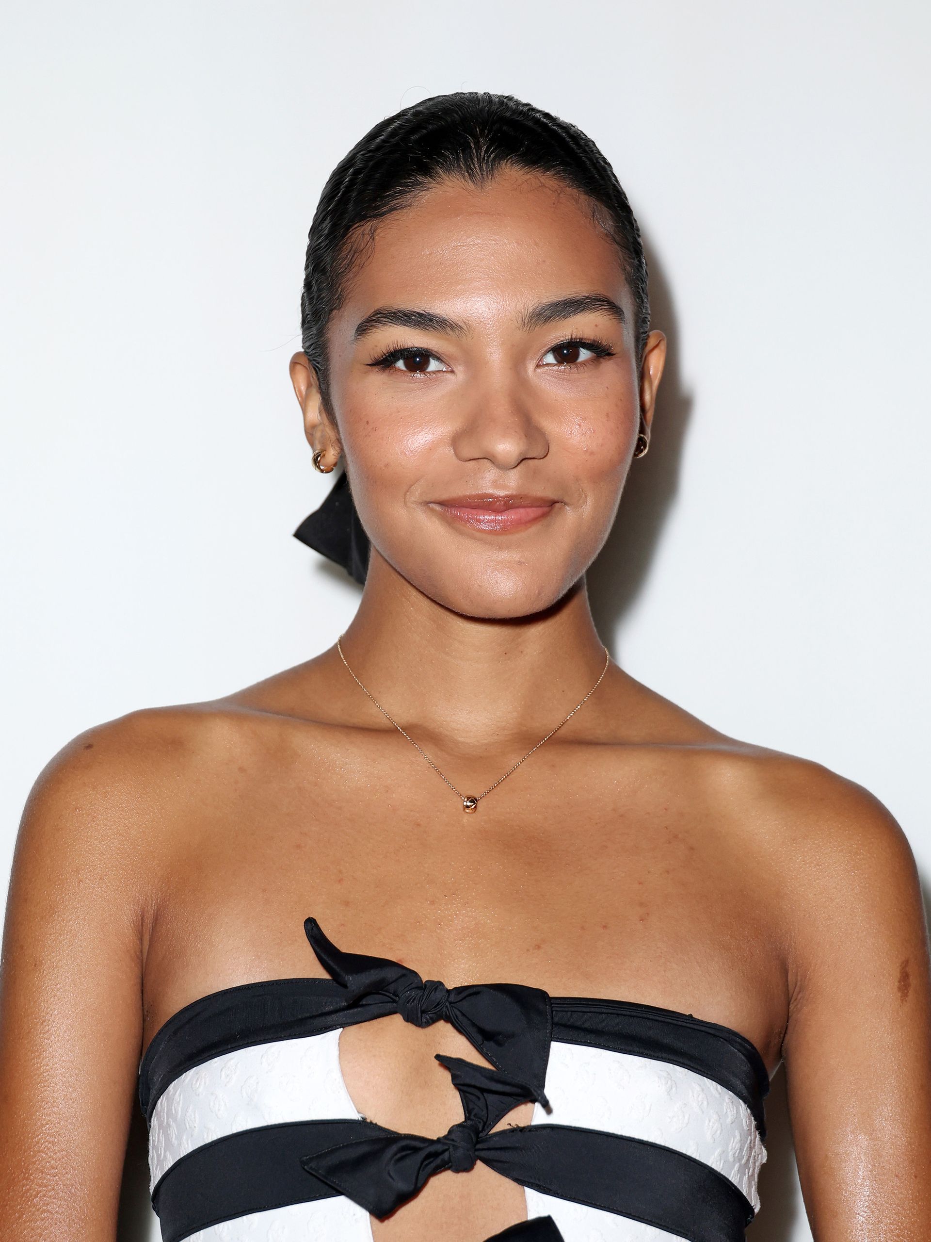 Olivia Dean attends the Chanel Womenswear fall/winter 2024-2025 during Paris Fashion Week with a glowy, bronzed complexion